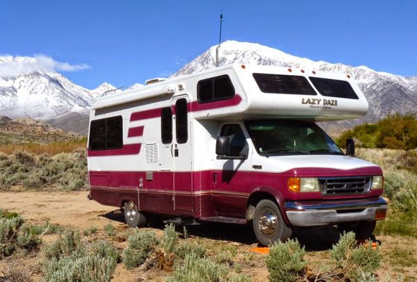 RV with snow capped mountains