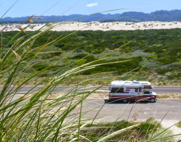 RV with sand dunes behind