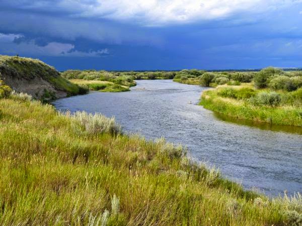 River on the prairie with cloudy sky