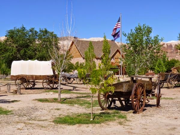 Cover wagon, flag pole and stone building