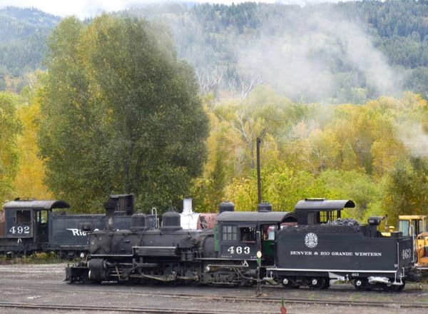 Train engines with steam rising
