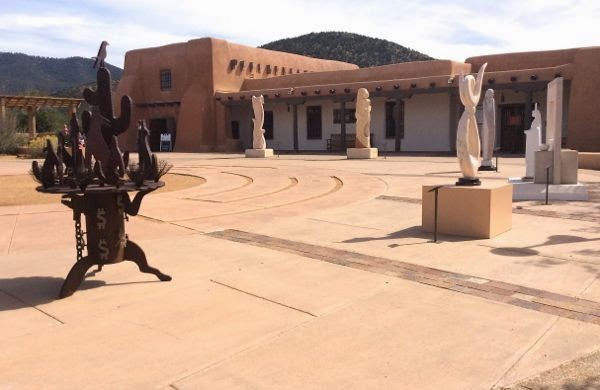 Sculpture patio with adobe building